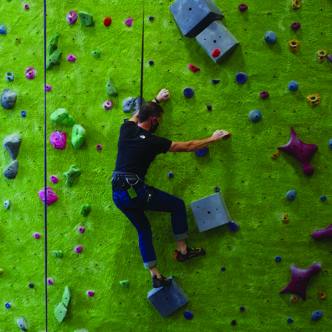 Man climbing on an indoor rock wall 